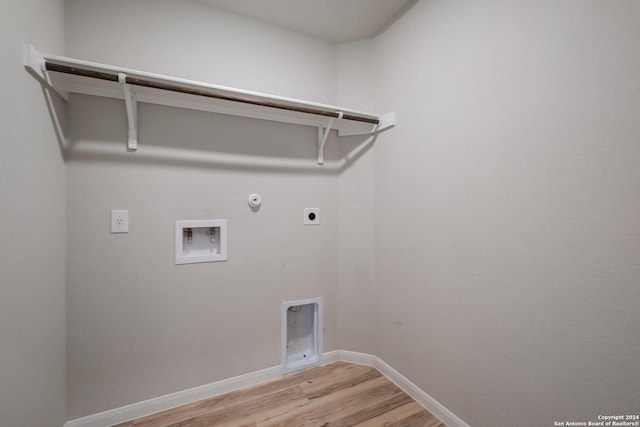 clothes washing area with hookup for a gas dryer, hookup for a washing machine, light wood-type flooring, and hookup for an electric dryer