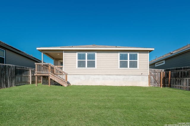 back of property featuring a lawn