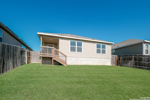 back of house with a lawn