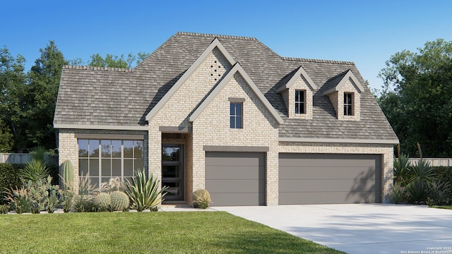 view of front of home with a garage and a front lawn