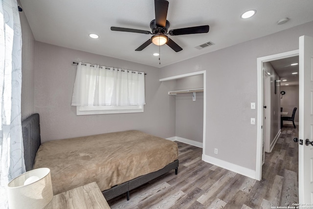 bedroom featuring ceiling fan, a closet, and wood-type flooring