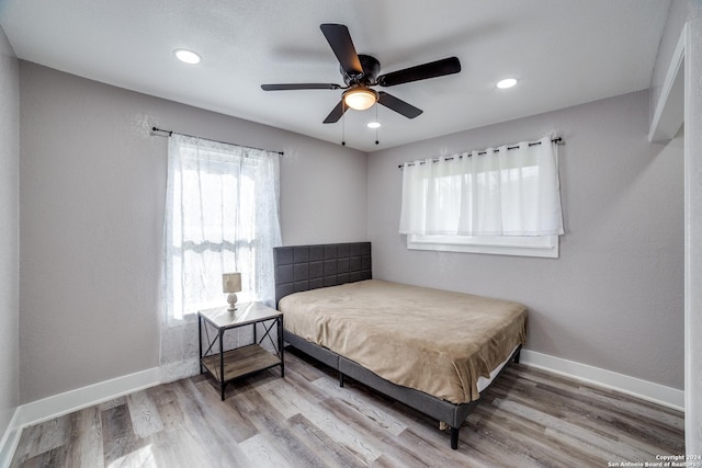 bedroom with hardwood / wood-style flooring and ceiling fan