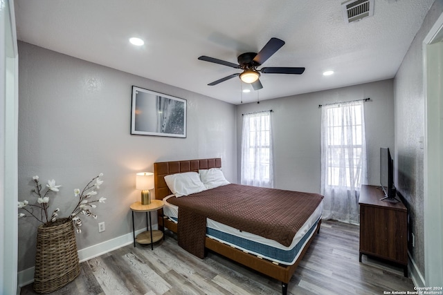 bedroom featuring hardwood / wood-style flooring and ceiling fan