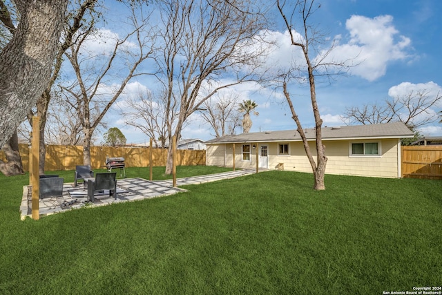 back of house featuring a lawn and a patio