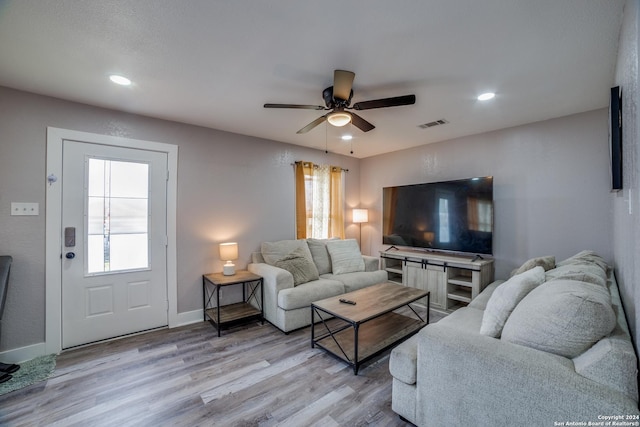 living room with ceiling fan and light wood-type flooring