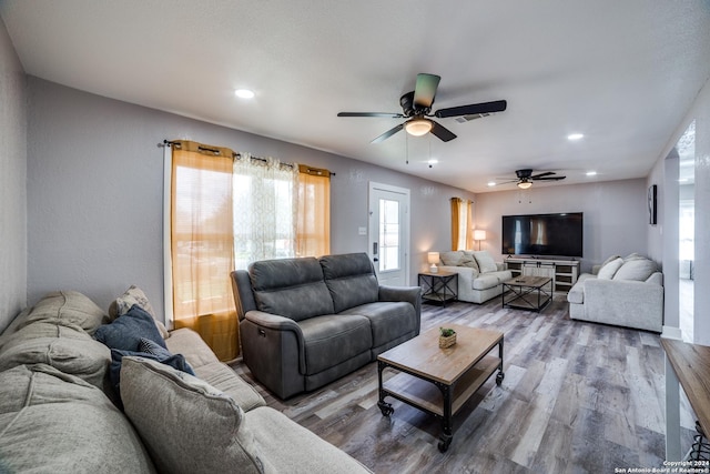 living room featuring a wealth of natural light, hardwood / wood-style floors, and ceiling fan