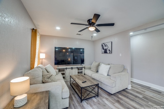 living room featuring ceiling fan and light wood-type flooring