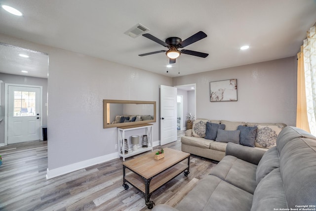 living room featuring hardwood / wood-style flooring and ceiling fan