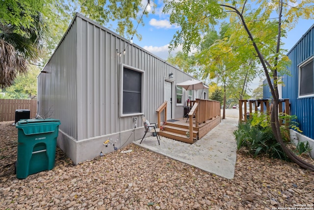 rear view of house featuring a patio area, cooling unit, and a deck