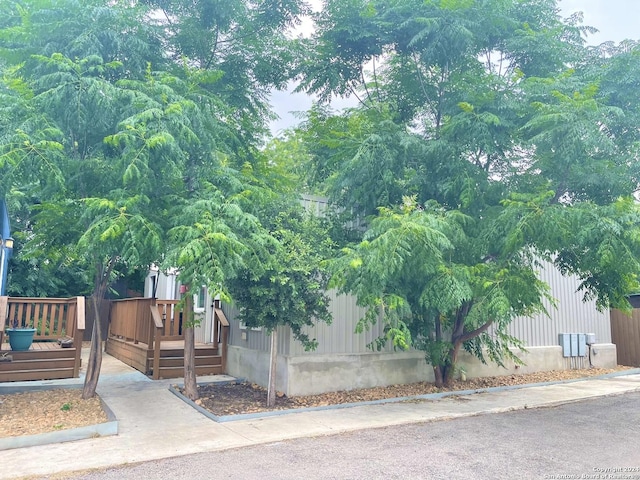 view of property exterior featuring a deck