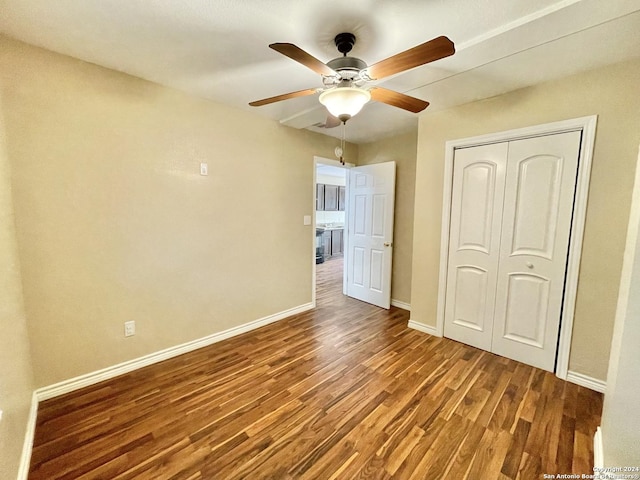 unfurnished bedroom featuring hardwood / wood-style flooring, ceiling fan, and a closet