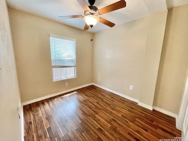 empty room with ceiling fan and dark hardwood / wood-style floors