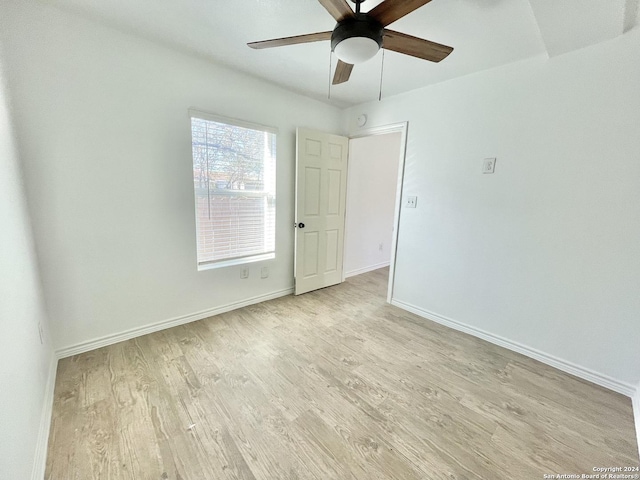 empty room featuring light wood-type flooring and ceiling fan