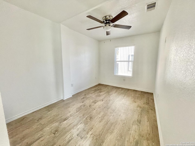 empty room featuring ceiling fan and light wood-type flooring