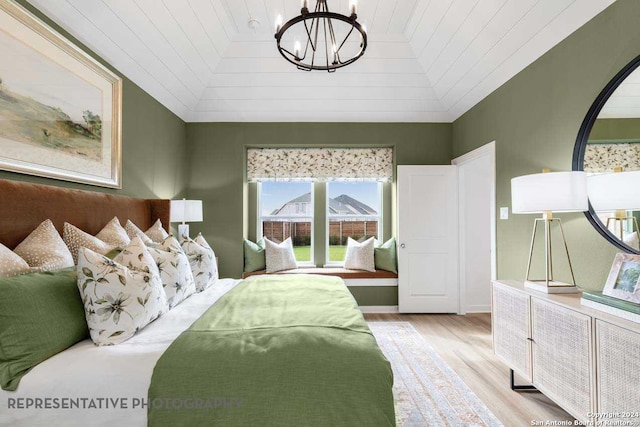 bedroom featuring a chandelier, lofted ceiling, light hardwood / wood-style flooring, and wooden ceiling