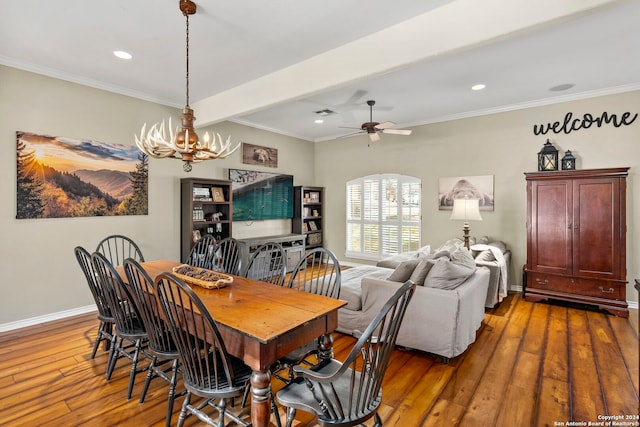 dining space featuring beamed ceiling, ceiling fan with notable chandelier, hardwood / wood-style flooring, and ornamental molding