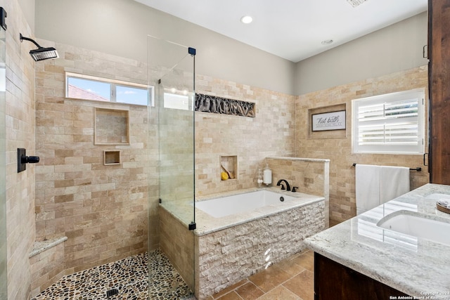 bathroom featuring vanity and plus walk in shower