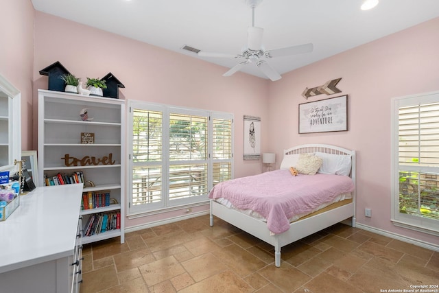 bedroom featuring ceiling fan and multiple windows