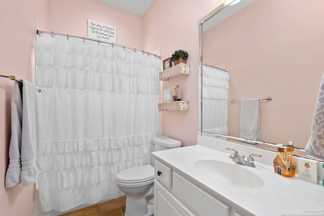 bathroom with vanity, curtained shower, and toilet