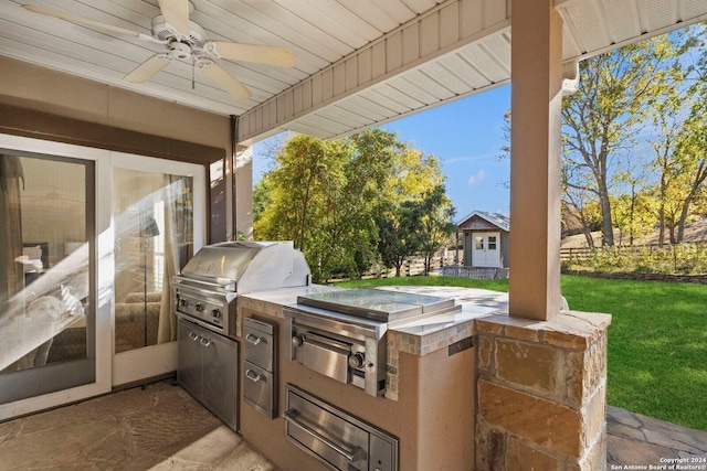 view of patio featuring area for grilling, ceiling fan, and an outdoor kitchen