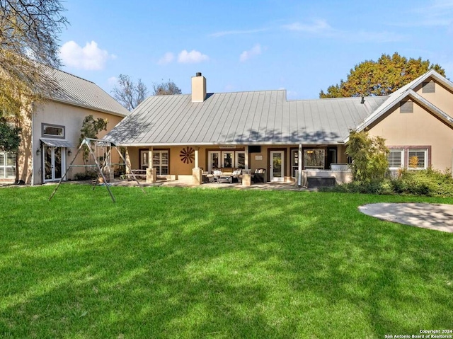 rear view of house featuring a patio area and a yard