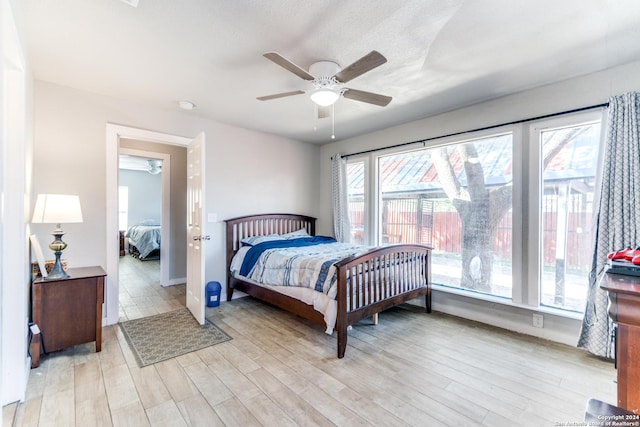 bedroom with ceiling fan and light hardwood / wood-style floors