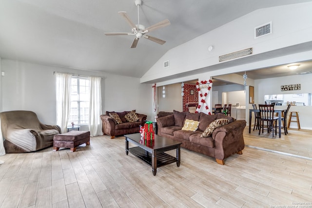 living room featuring ceiling fan, light wood-type flooring, and lofted ceiling