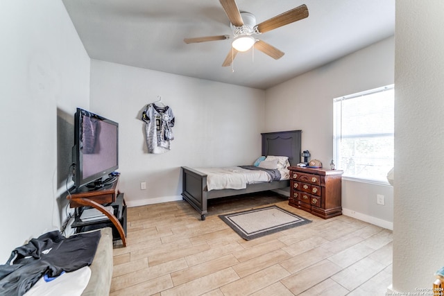 bedroom with light hardwood / wood-style floors and ceiling fan