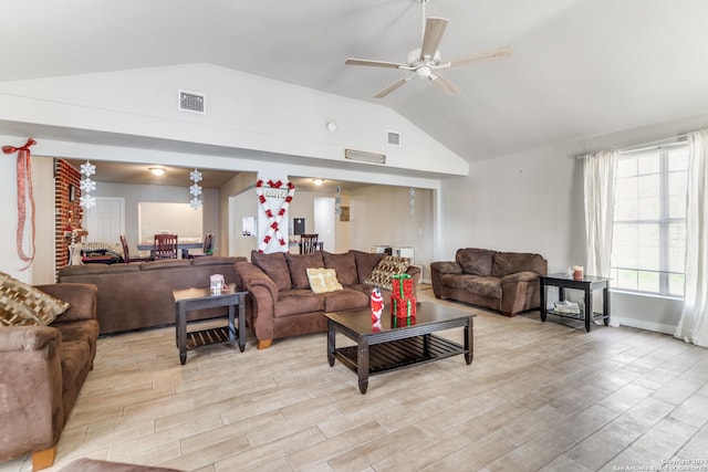 living room featuring ceiling fan, lofted ceiling, and light hardwood / wood-style flooring