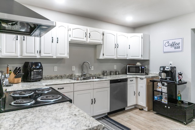 kitchen featuring sink, range hood, appliances with stainless steel finishes, white cabinets, and light wood-type flooring