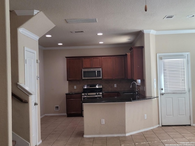 kitchen with backsplash, sink, light tile patterned flooring, and appliances with stainless steel finishes