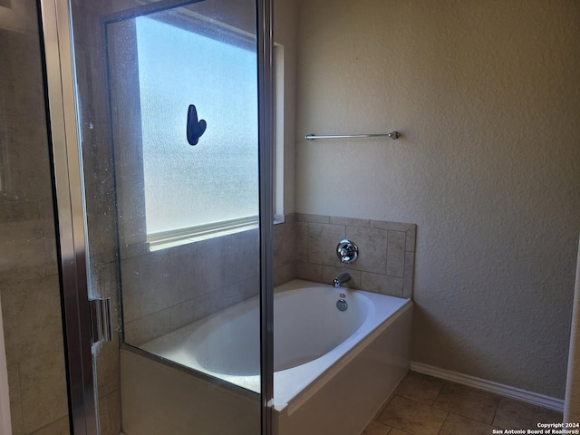 bathroom with tile patterned floors and independent shower and bath