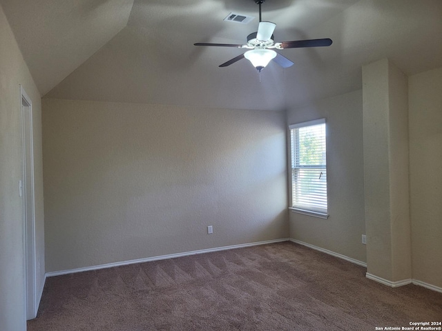 unfurnished room with carpet flooring, ceiling fan, and vaulted ceiling