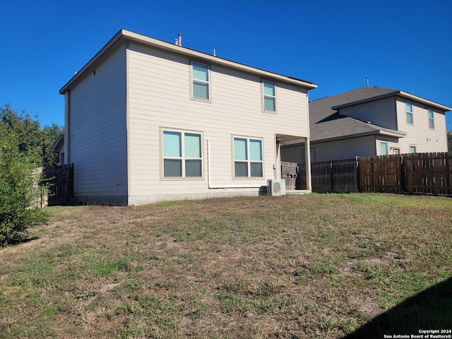 rear view of property with a lawn