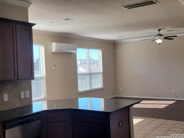 kitchen featuring an AC wall unit, tasteful backsplash, plenty of natural light, and stainless steel dishwasher