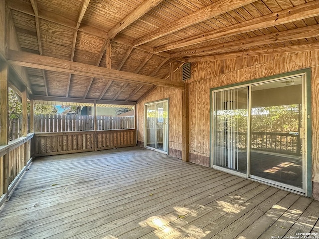 unfurnished sunroom featuring vaulted ceiling with beams and wooden ceiling