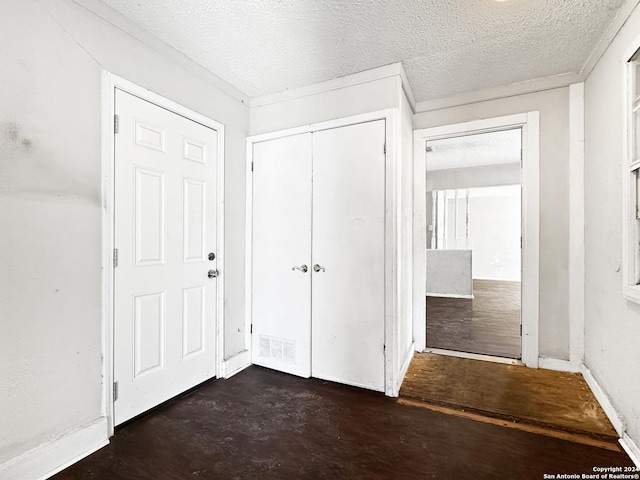 interior space with a closet and a textured ceiling