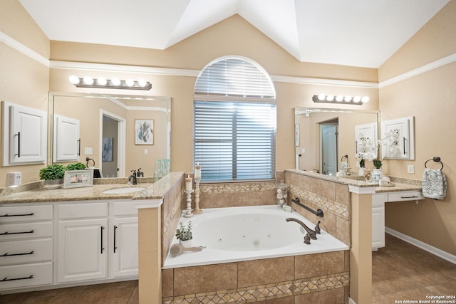 bathroom with tile patterned flooring, a relaxing tiled tub, lofted ceiling, and vanity