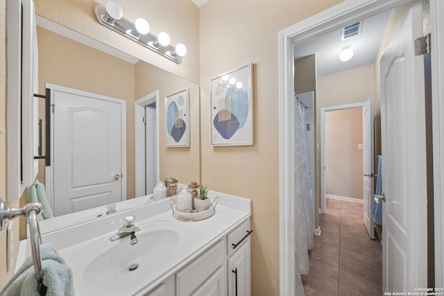 bathroom featuring tile patterned flooring and vanity