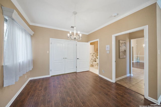 interior space featuring ornamental molding, dark hardwood / wood-style floors, and a notable chandelier