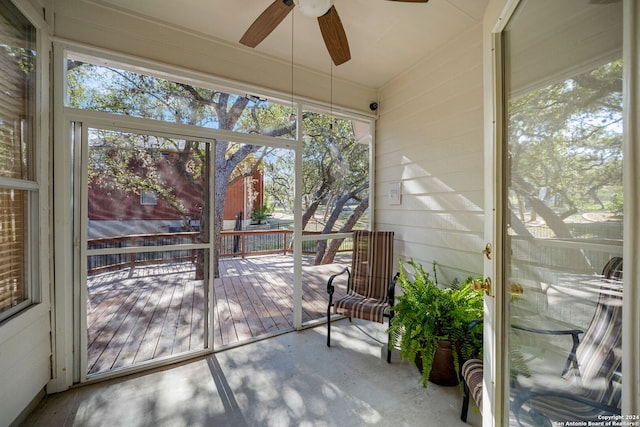 unfurnished sunroom featuring ceiling fan