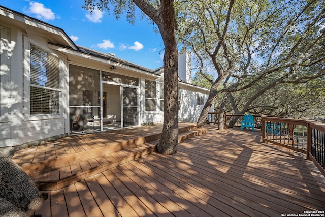 wooden terrace featuring a sunroom