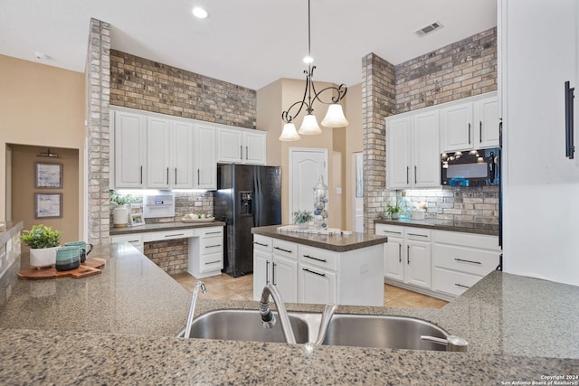 kitchen with sink, backsplash, white cabinetry, and black appliances