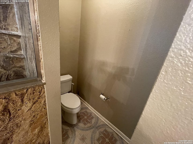 bathroom with tile patterned floors and toilet