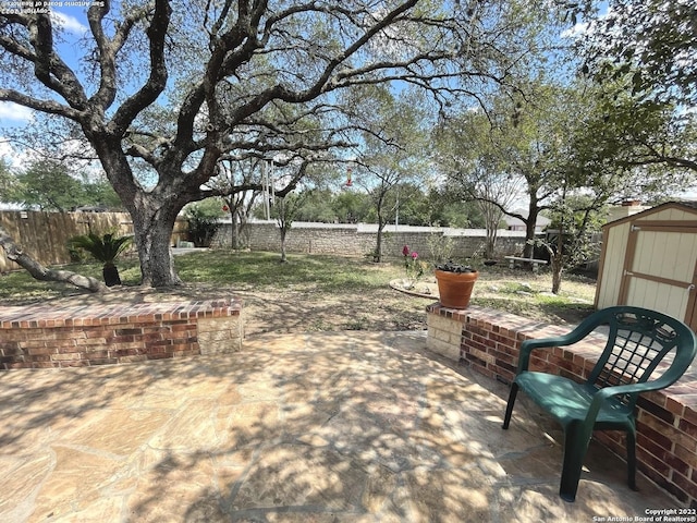 view of patio with a storage shed