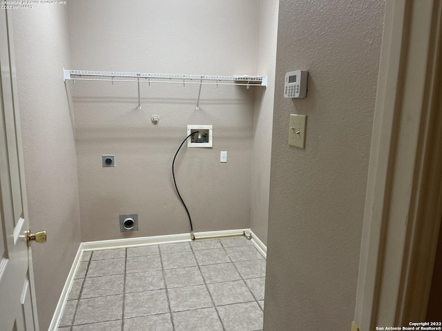 laundry room with gas dryer hookup, hookup for a washing machine, light tile patterned floors, and hookup for an electric dryer