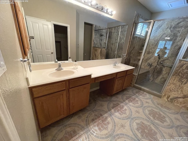 bathroom featuring vanity and an enclosed shower