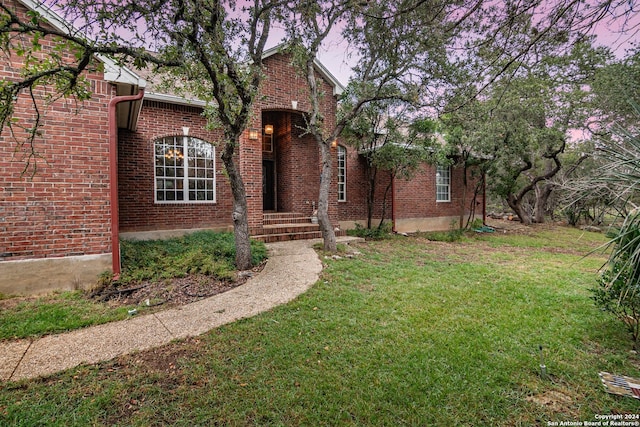 view of front of home with a lawn