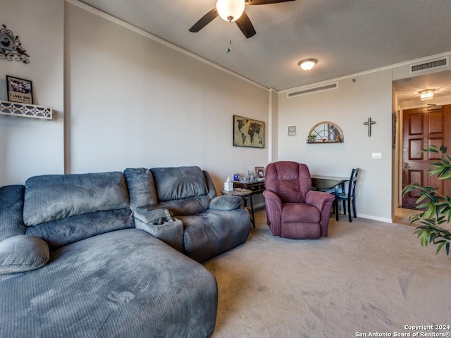 carpeted living room with ceiling fan, ornamental molding, and a textured ceiling