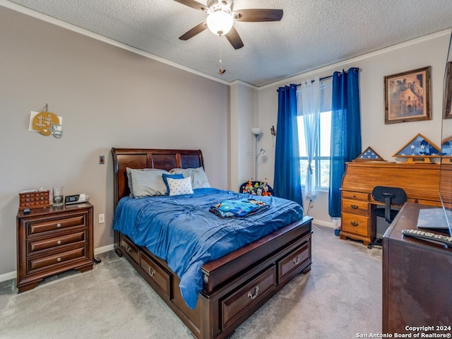 bedroom with ceiling fan, crown molding, light colored carpet, and a textured ceiling